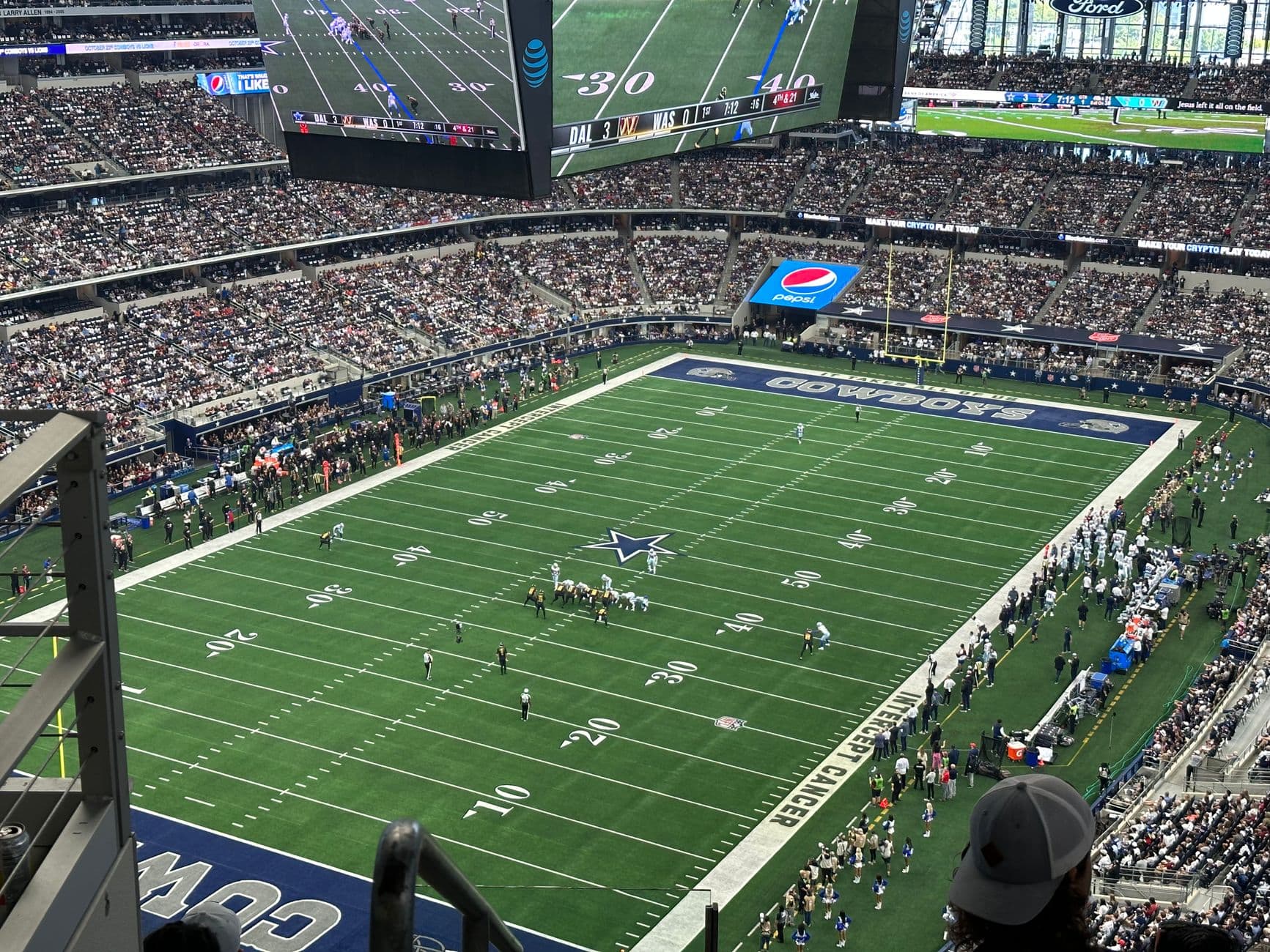 An exciting aerial shot of a football game at a packed stadium, showcasing team action on the field.
