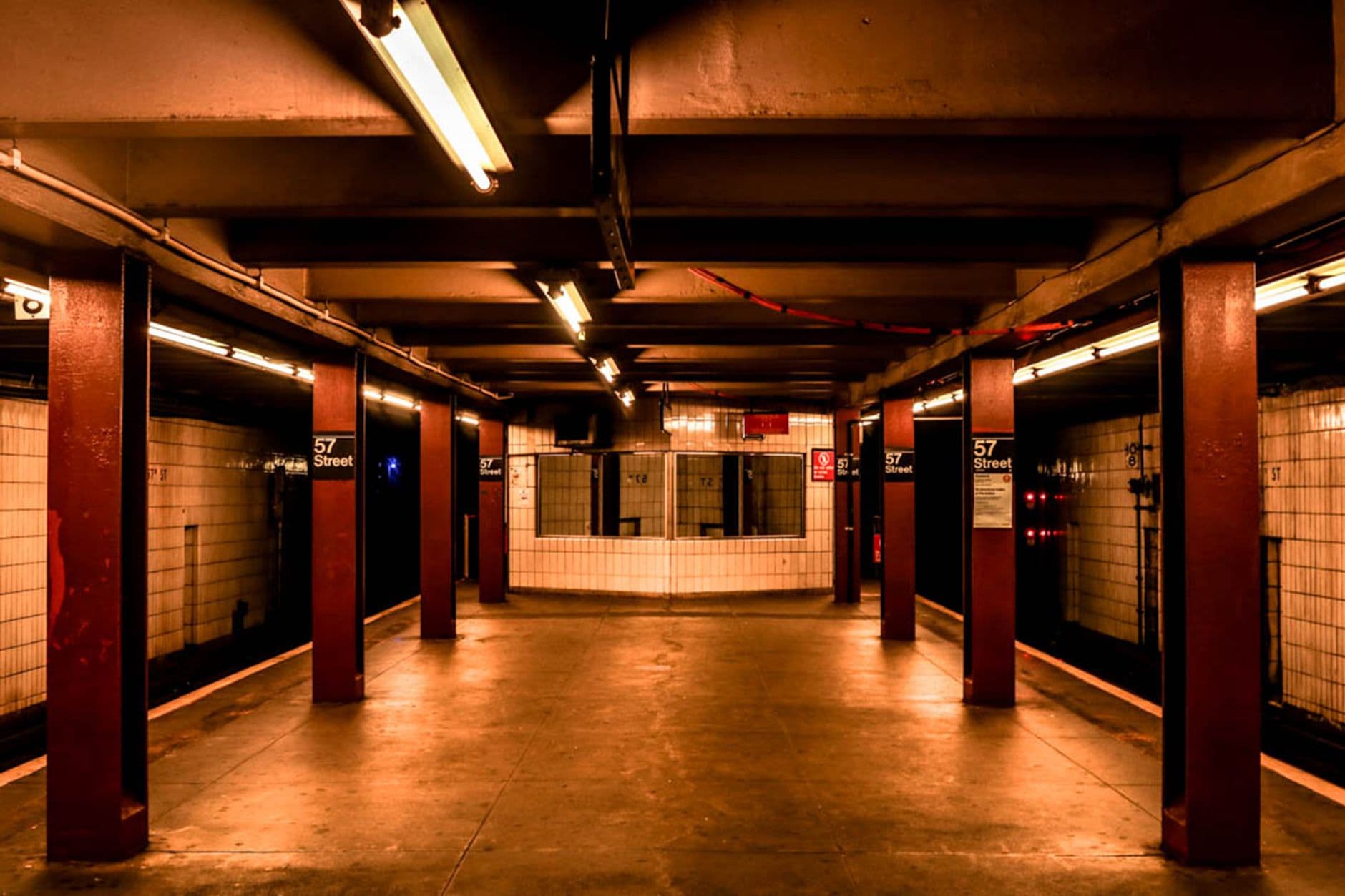 A deserted subway platform in 57th Street Station, New York City, showcasing urban architecture.